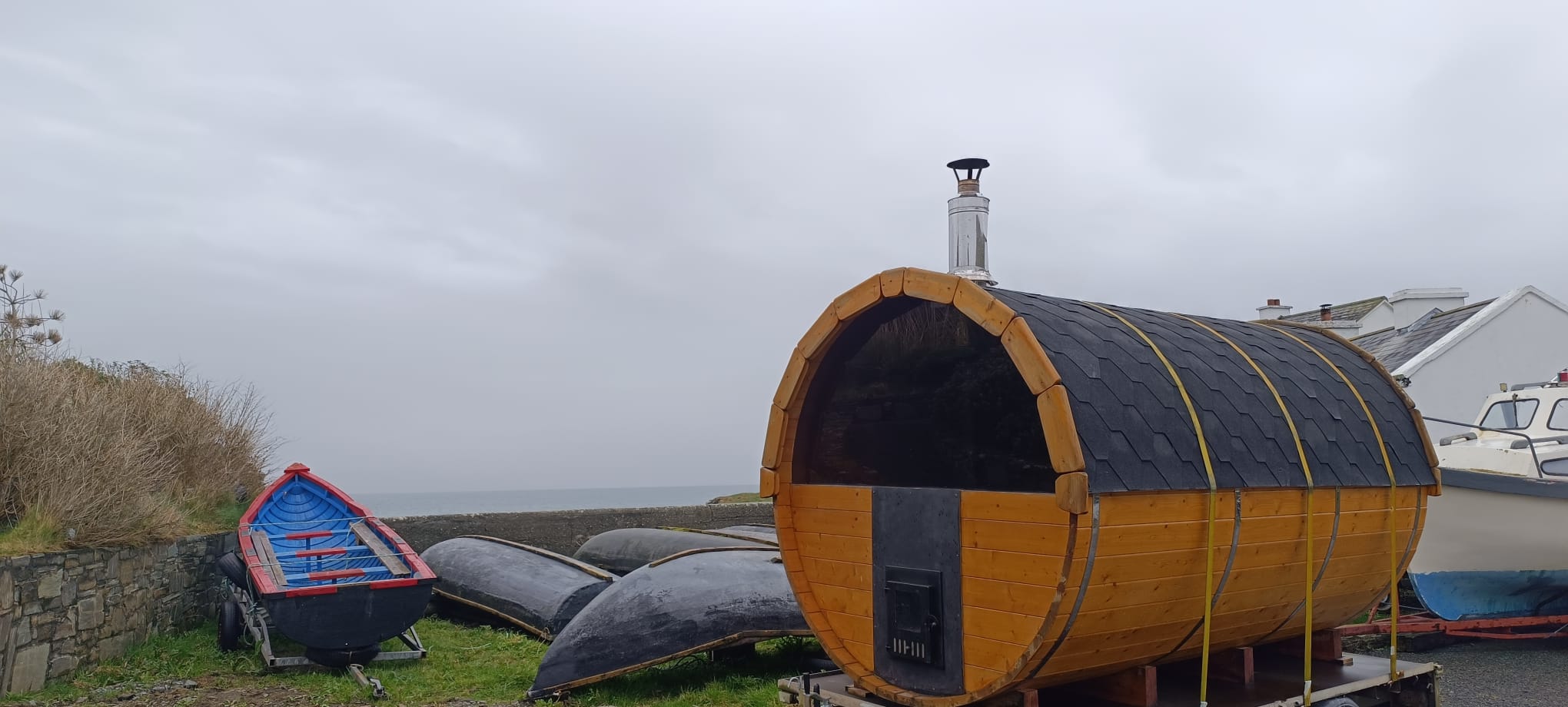 The sauna with traditional currachs and Atlantic behind