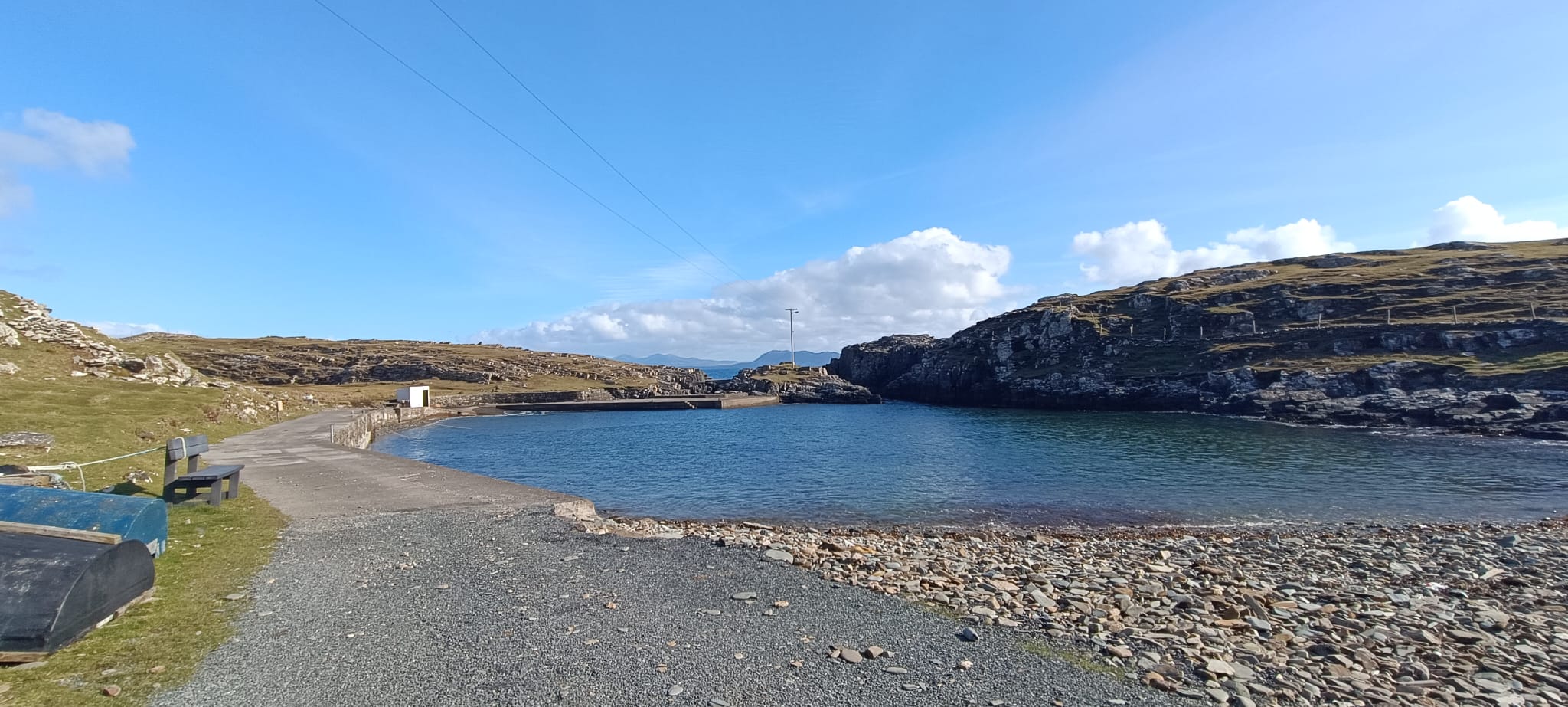 The harbour with stone beach and turned-over currachs