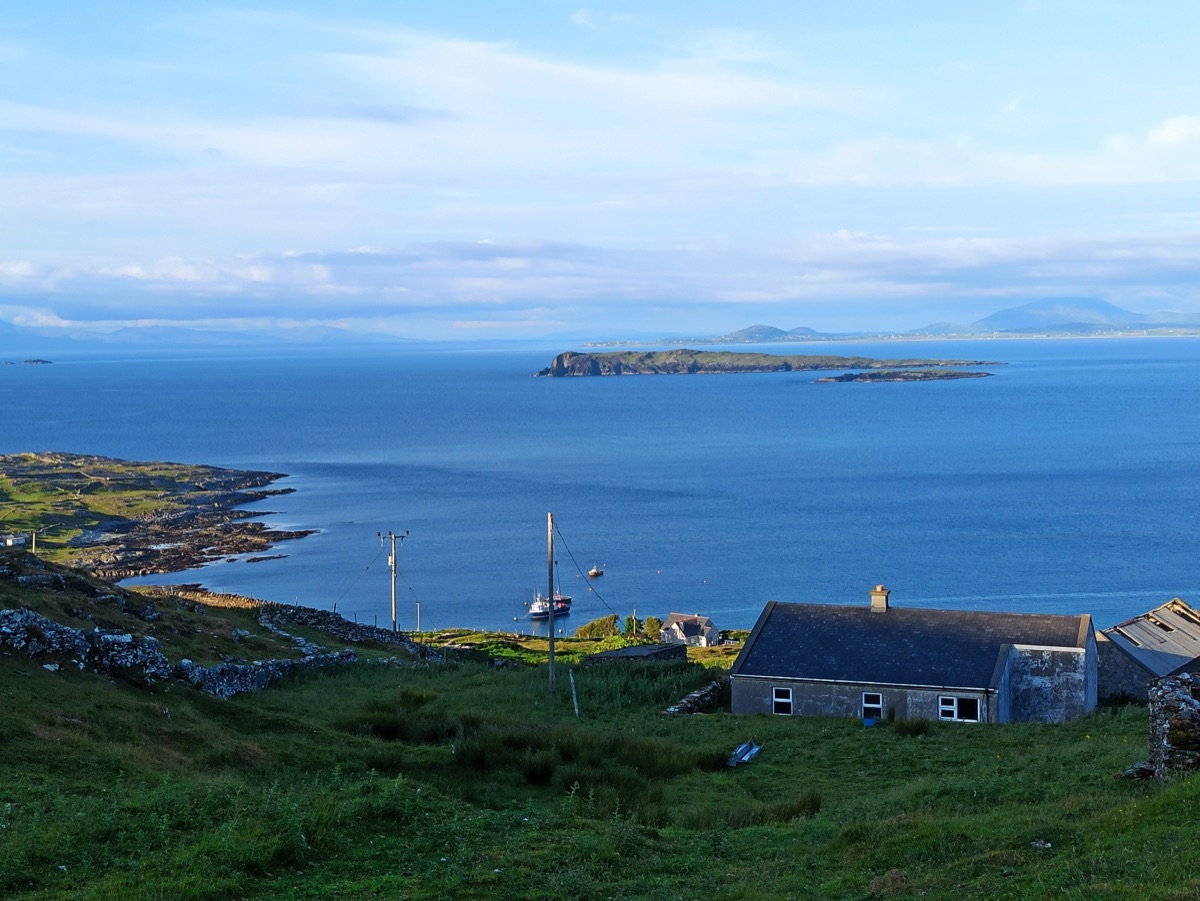 View from the hilltop across Inishturk — harbour, houses, stone walls, islands beyond
